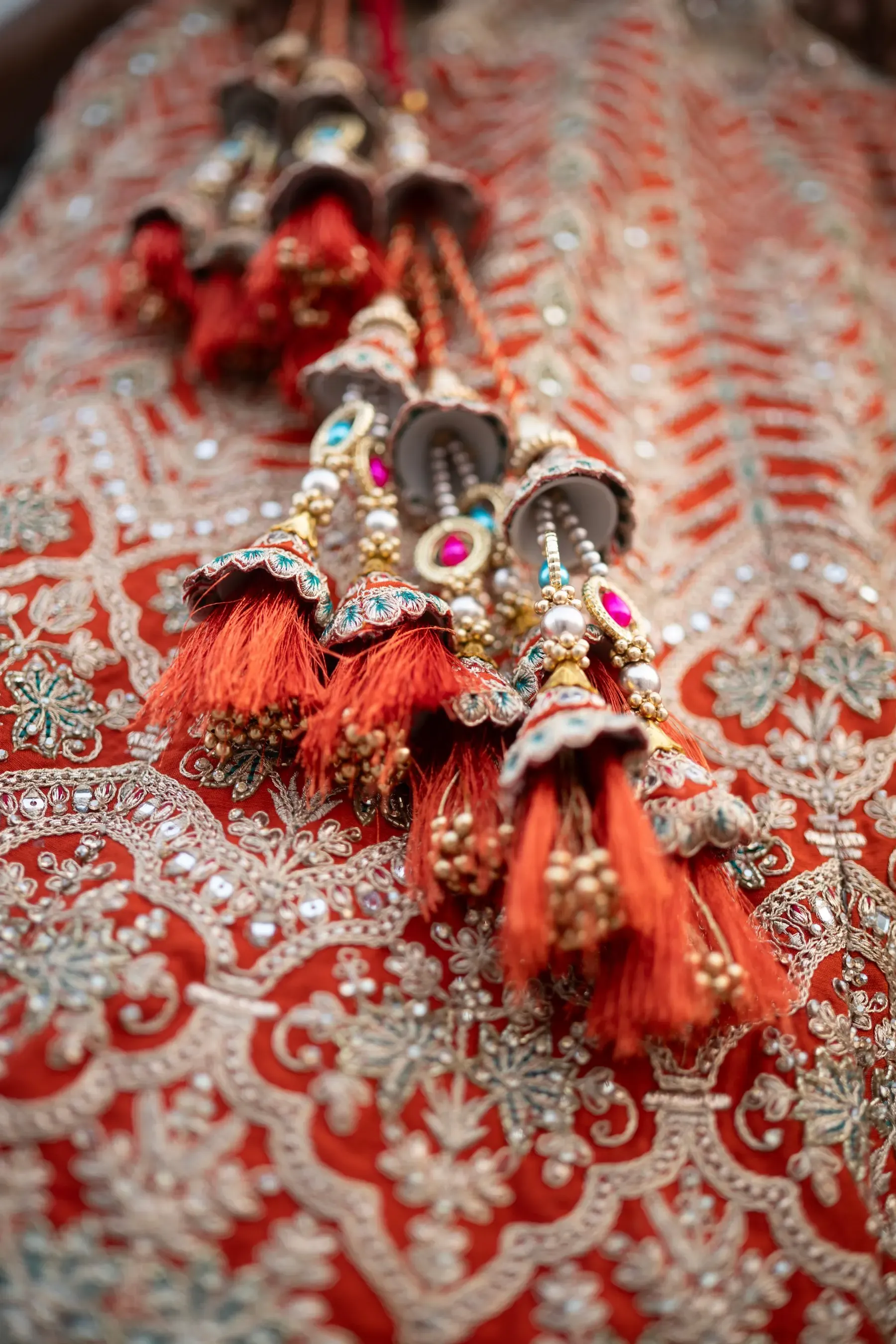 Hand made tassels on the drawstring of a red embroidered lehenga