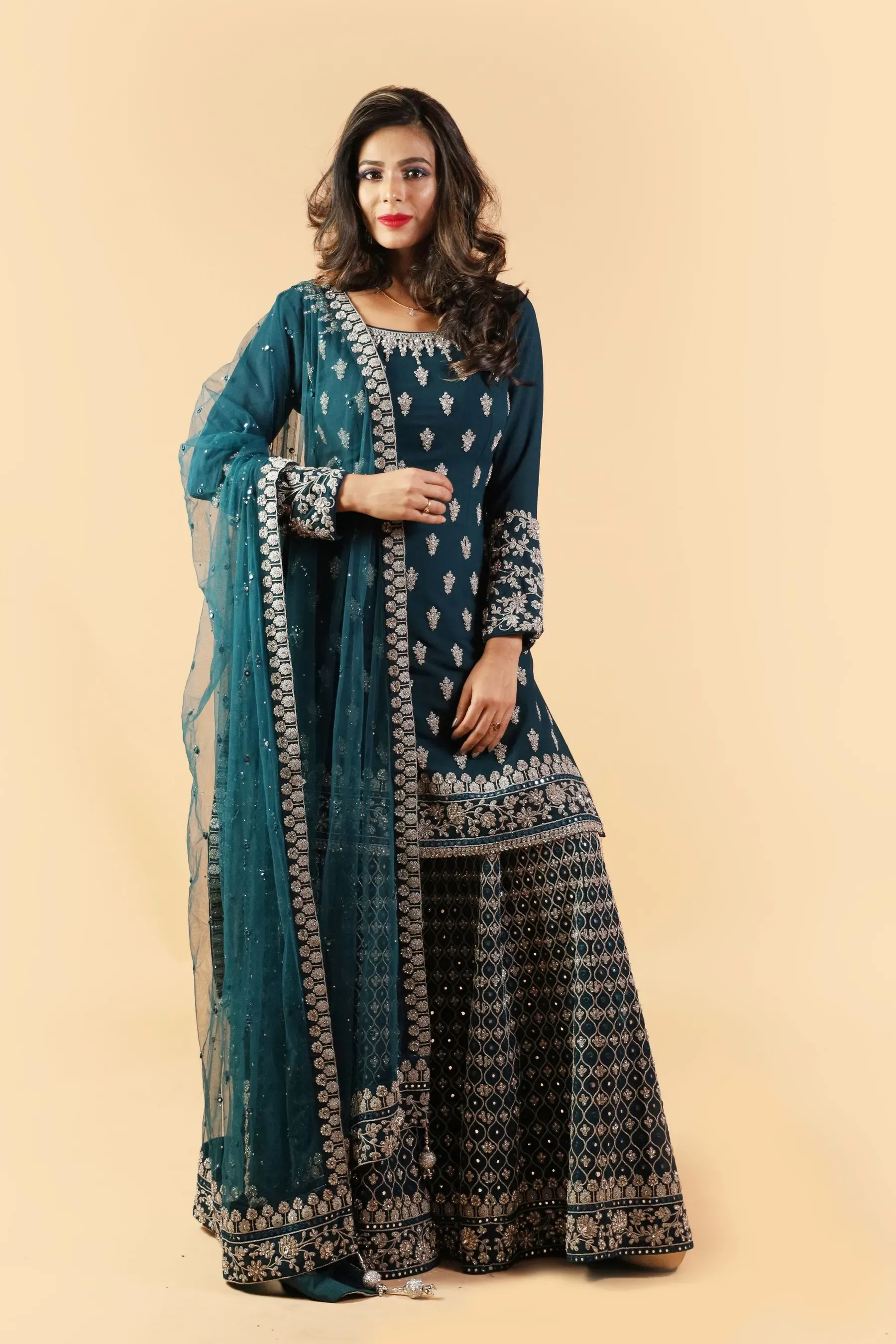 Model in the Neelam teal sharara set in the studio